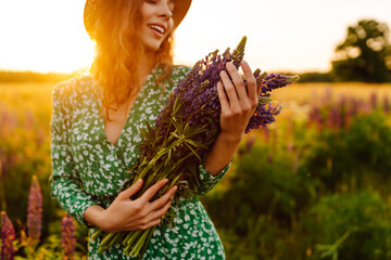 Beautiful woman stands  on blooming fragrant lavender fields. Nature, vacation, relax and...