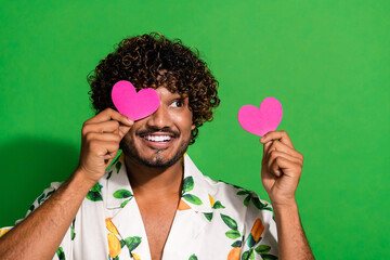 Photo of cool dreamy latin guy dressed print shirt pink heart postcard close eye looking empty...