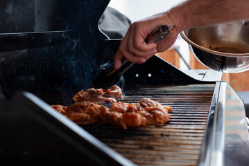 cooking a chicken in the grill in a party outdoors