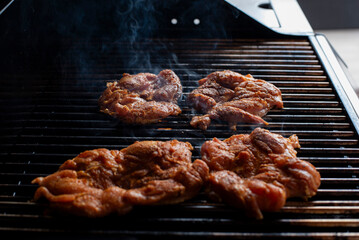 cooking a chicken in the grill in a party outdoors