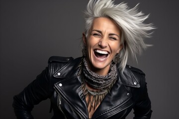 Portrait of a beautiful woman with blond hair in a leather jacket - obrazy, fototapety, plakaty