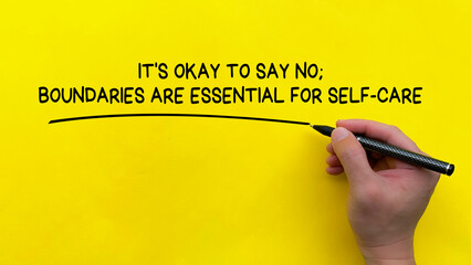 Hand writing It is okay to say no affirmation on yellow cover background. Affirmation concept.