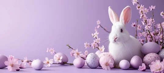 Foto op Canvas white rabbit with easter eggs and flowering branch on the purple background © Kateryna Kordubailo