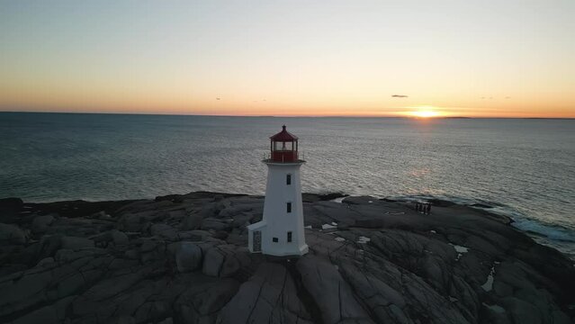 Peggy Cove Lighthouse at Sunset Atlantic Coastline Halifax Nova Scotia Canada.Calm and magical sunset on a picturesque rocky coast.Aerial view of breathtaking natural scenery with a working lighthouse
