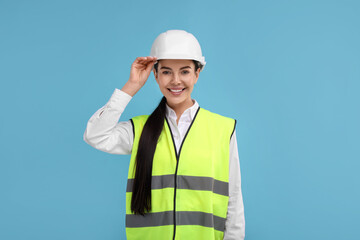 Engineer in hard hat on light blue background