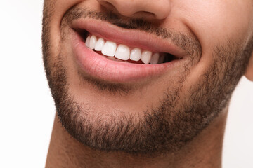 Fototapeta premium Smiling man with healthy clean teeth on white background, closeup