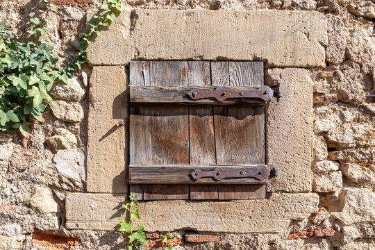 Mittelbergheim, France - 09 10 2020: Alsatian Vineyard. Close up of a wall with a window and a closed wooden shutter.