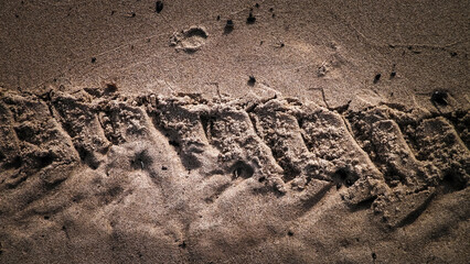 Traces of motorbike on beach.