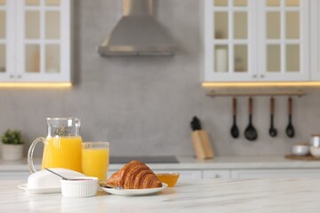 Breakfast served in kitchen. Fresh croissant, jam, honey and orange juice on white table. Space for text - obrazy, fototapety, plakaty