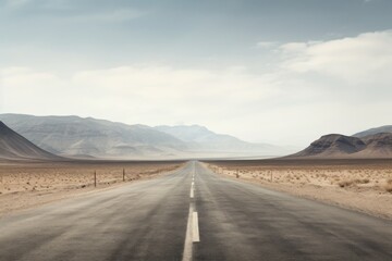 Fototapeta premium An empty road cutting through a stark, arid desert landscape