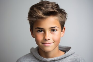 Portrait of a cute little boy in grey sweater, studio shot