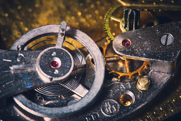 Macro view of gears in an old wall clock mechanism.