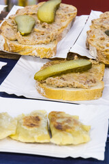 Fresh homemade dumplings and portion of wheat or rye bread with lard and pickled cucumber. Traditional polish food