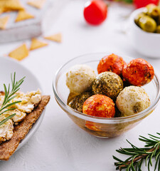 Small balls of goat cheese rolled in different spices