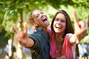 Friends, portrait and women with rock hands at music festival outdoor, bonding and fun together at summer event. Smile, horn sign and happy girls at party for celebration, excited or laugh in nature