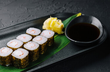 Traditional fresh japanese sushi maki on black stone plate