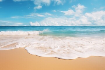 Calm ocean waves rolling onto a sandy beach under a clear sky