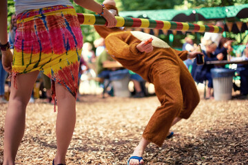 Limbo, game and person at party outdoor with balance and playing at a music festival, event or...