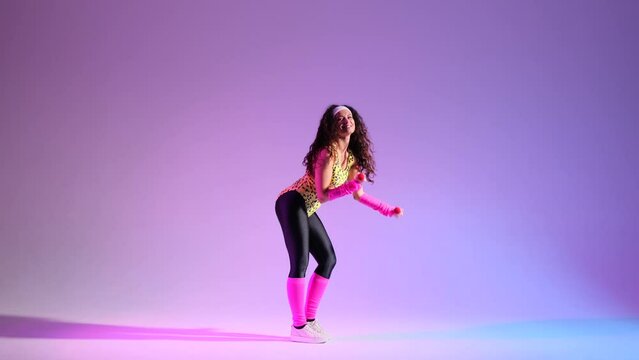 Against a purple backdrop, cheerful girl in a lively 80s aerobics session. With a smile, she using dumbbells, bringing a retro flair to energetic workout.