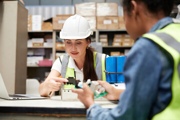 factory workers checking and fixing small machine or mainboard in the factory