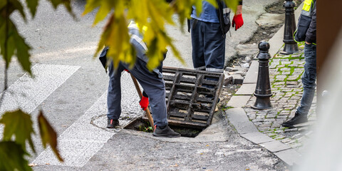 Group of unrecognizable workers repair street, performing tasks to maintain and improve road and...