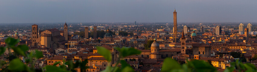 Panoramic image of the enchanting allure of Bologna's medieval charm as the sun sets, casting a warm glow over the historic cityscape