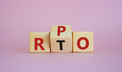 RPO vs RTO symbol. Wooden cubes with words RTO to RPO. Beautiful pink background. business concept. Copy space