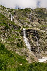 Waterfall while hiking Tour du Mont Blanc. Popular hiking route. Alps, Val D'Aoste, Italy, Europe.