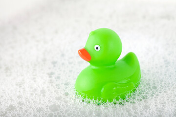 Green rubber duck toy floating in water