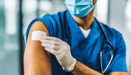 shoulder with bandaid after COVID vaccine, symbolizing vaccination and healthcare