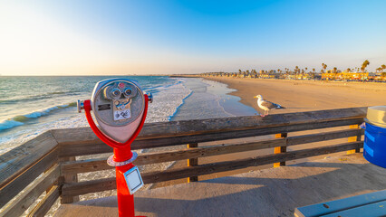 Touristic telescope in Newport Beach pier at sunset - Powered by Adobe