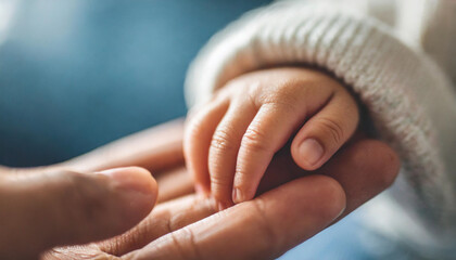 Newborn baby's tiny hand gently folded over adult's hand, symbolizing love, guidance, and new beginnings