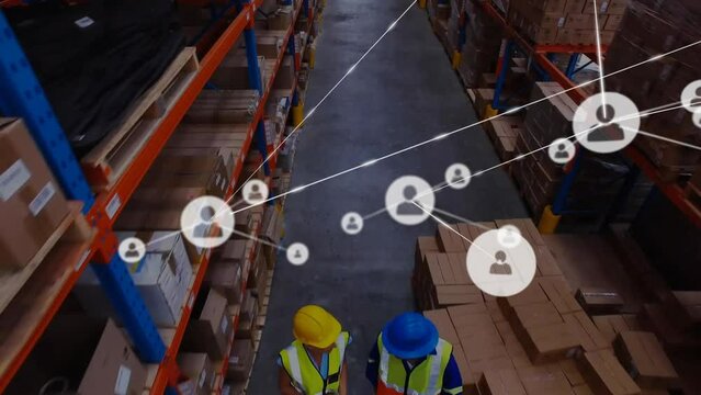 Animation of network of people icons over diverse workers moving boxes at warehouse