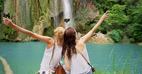 Selfie, friends and travel in nature for social media, website and relaxing on waterfall vacation. Women, back and profile picture or influencers on summer holiday, update and live streaming for vlog