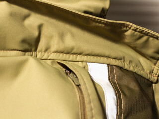 Khaki workwear protective clothing reflector inserts close-up details.