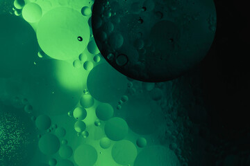 dark abstract liquid background with glowing green light