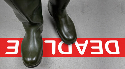 A red line marks the deadline. Military rubber boots resolutely cross them. Time is ticking,...