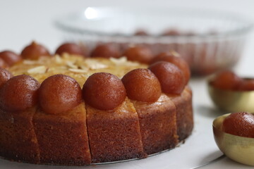 Gulab Jamun Cake decorated with gulab jamun on top. Irresistible fusion dessert, combining flavors...