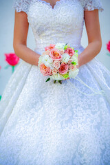 Woman in Wedding Dress Holding Bouquet of Flowers