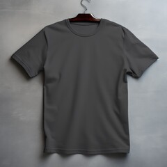 Charcoal t shirt is seen against a gray wall