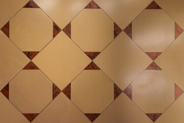 A pattern of diagonally arranged square tiles in various shades of brown