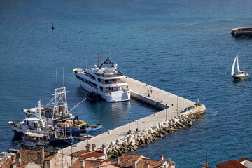 Aerial view of port. Typical red ceramic roof tile and pier with a moored ship, Rovinj; Croatia; Istria