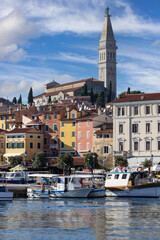 Fototapeta premium Colorful tenement houses on the boulevard by the port over Adriatic Sea, moored boats, Rovinj, Croatia, Istria