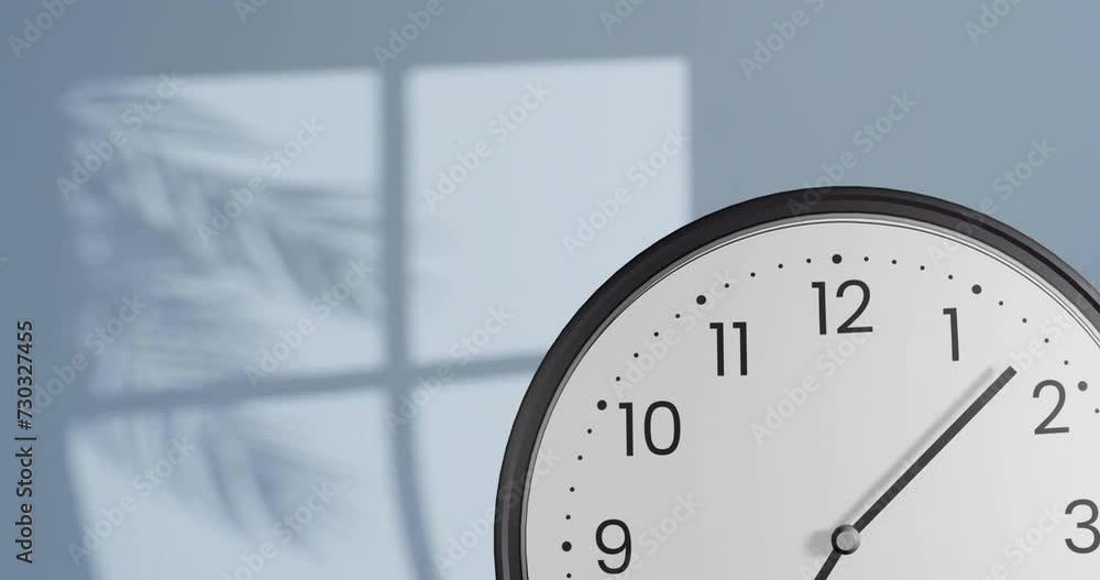 Aufkleber animation of fast moving hands on clock over wall with shadow of leaves and window