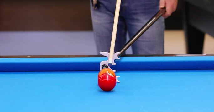 Male hands train with device for cue in pool game, close up