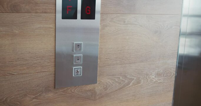 Human hand finger presses up button calling elevator in close-up slow motion. Elevator call symbol of modern technology Elevator call ascending to heights Waiting for transport in modern buildings.