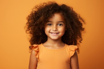 portrait of smiling african american little girl with curly hair