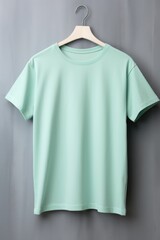 Mint t shirt is seen against a gray wall