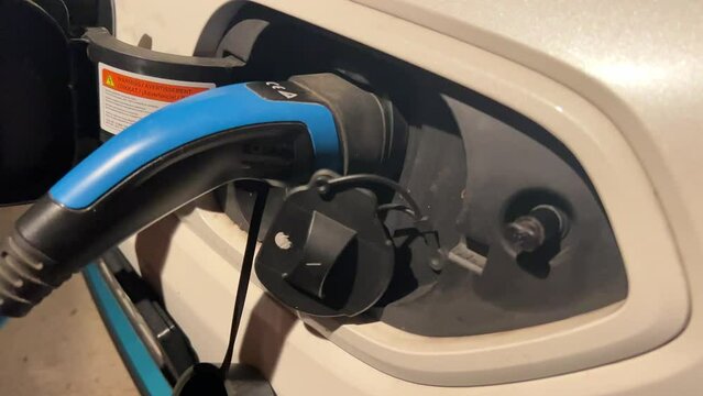charging adapter plugged in electric car socket