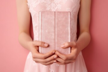 closeup of youthful, graceful hands holding a pastel pink clutch with a delicate touch, hinting at a cherished belonging or an awaited occasion